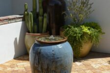 24 a large vase fountain placed in your desert garden or patio is a cool piece of attraction to rock it, it will bring more peace and relaxation