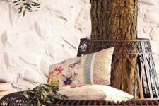26 a sophisticated and chic metal bench around the tree, with printed pillows and greenery is a lovely item to sit on