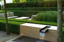 30 a minimalist water feature – a waterfall on a slab of stone, with greenery around, is a stylish idea for any contemporary or minimalist space