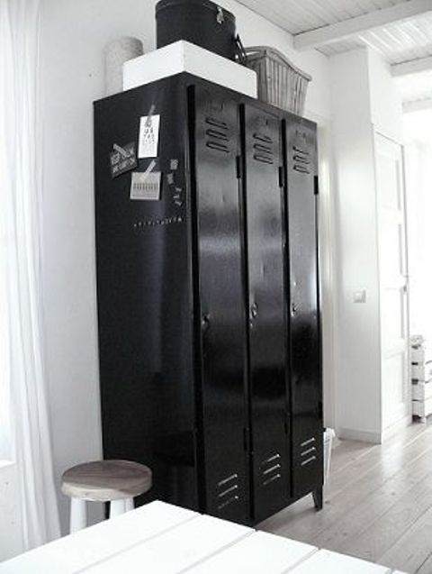 a Scandinavian space with black metal lockers that are used inside and outside fro storage and will make a statement in the space
