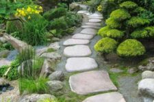 a Zen-like garden with lots of greenery and creative moss arrangements, a large stone garden path that looks super cool