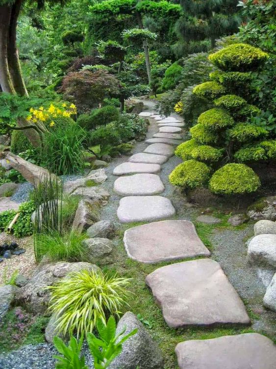 a Zen-like garden with lots of greenery and creative moss arrangements, a large stone garden path that looks super cool
