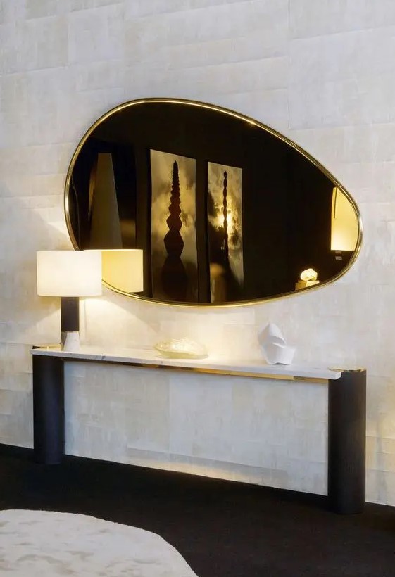 a beautiful gold egg-shaped mirror will add warm glow to the space and will make it softer with its shape and cool look