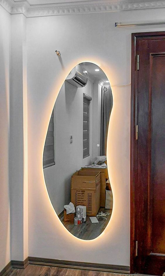 a beautiful irregularly shaped mirror with lights is a cool idea not only for an entryway but also for many other spaces