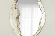 a beautiful mirror in a unique frame resembling a piece of land or rorck is a gorgeous idea to try