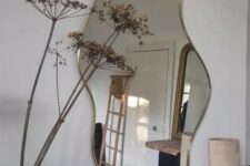 a beautiful organic-shaped mirror in a super delicate brass frame is a lovely solution for a Scandinavian space
