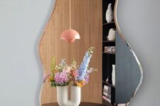 a beautifully shaped mirror with a gold edge is a gorgeous wall decoration, which is not wose than artwork