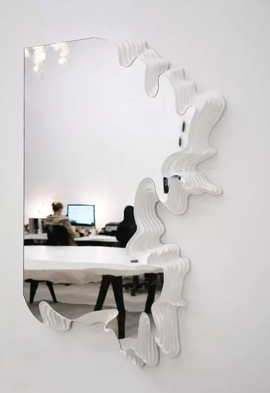 a beautifully shaped mirror with en edge that resembles a puzzle piece is a unique idea for a modern space, such partial framing will be great
