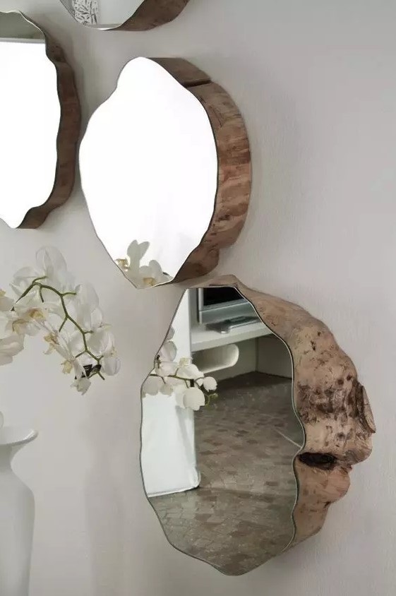 a bold and catchy arrangement of mirrors of rough wood covered with mirrors is amazing for adding a natural feel to the space
