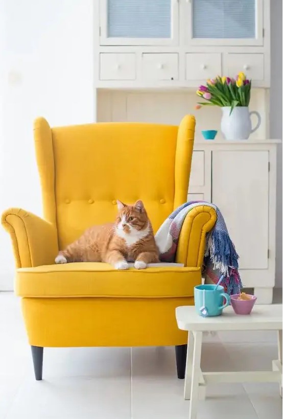 a bold yellow IKEA Strandmon chair will add a cheerful touch and plenty of color to your space making it more spring or summer-like