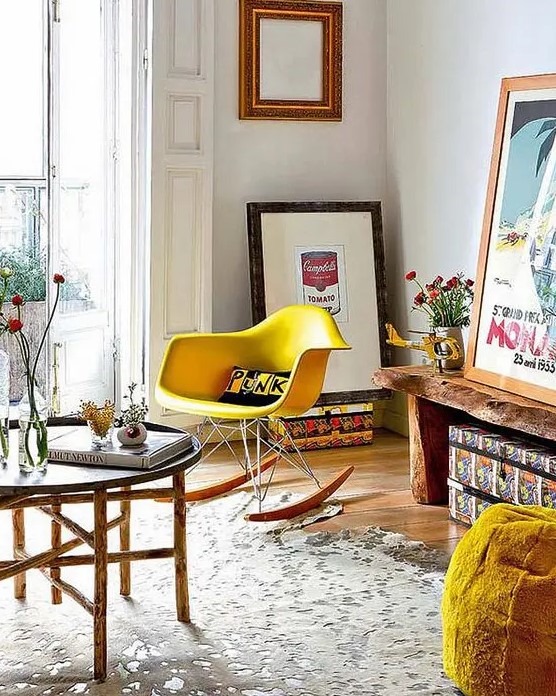 a bright mid-century modern space with a living edge bench, a yellow Eames rocker, an Easten style coffee table and some artwork