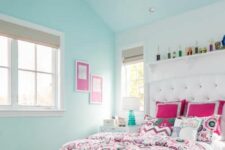 a bright teenage bedroom in light turquoise, with a bed and bold bedding, a shelving unit with decor