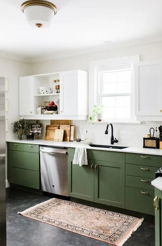 a chic modern kitchen with olive green and white cabinets, gold handles and white countertops plus a boho rug