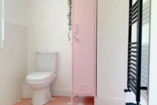 a cool bathroom with a pink star print floor, a pink skinny locker for storing stuff, a black radiator is a lovely space
