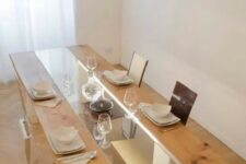 a creative dining table with a glass and wood tabletop and white legs plus built-in lights is a stylish idea for a modern dining room