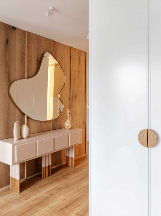 a creatively shaped mirror is a beautiful idea for any entryway, it will add eye-catchiness and a bold touch to any modern space