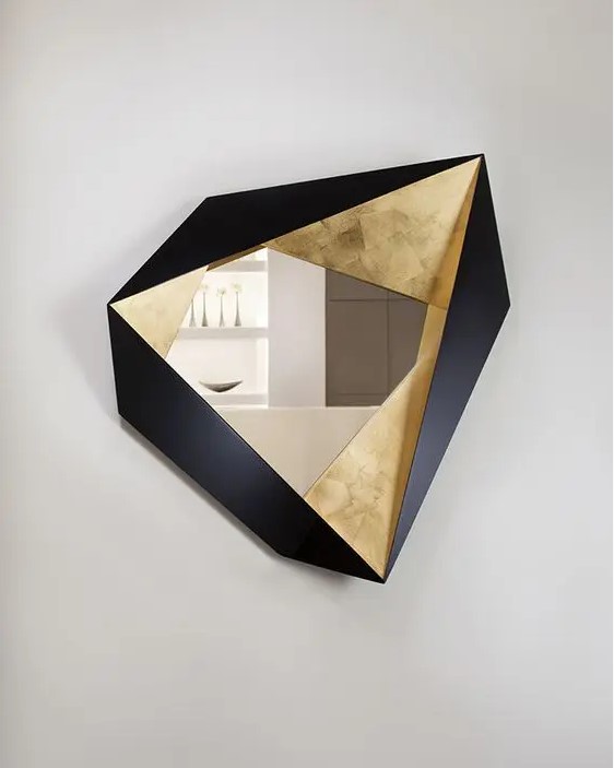 a fabulous faceted geometrically shaped mirror with gold and black timber parts is a fantastic artwork, not just a usual mirror