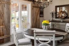 a farmhouse wooden dining area with a statement stained wood ceiling and shutters, vintage white furniture and a framed mirror