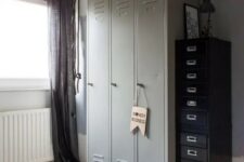 a kid’s space finished off with grey lockers, with black flie cabinets that provide a lot of storage space