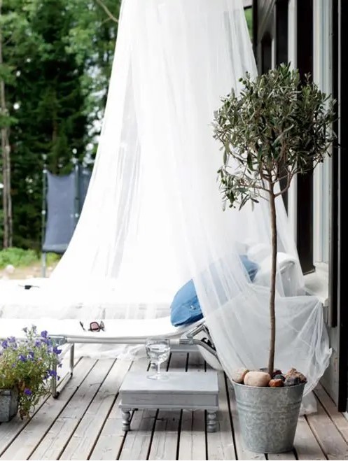 a lounger covered with a mosquito net will help you avoid excessive sunshine, bugs and will give a more relaxed feel to your space