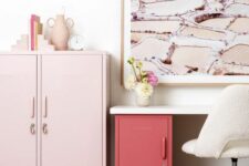 a lovely and cute working space with a desk with a red locker fro storage, a pink locker and a pink artwork plus a creamy chair