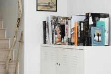 a low locker console with books and shoes is a cool idea for any space, a living room, an entryway or some other room
