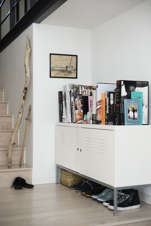 a low locker console with books and shoes is a cool idea for any space, a living room, an entryway or some other room