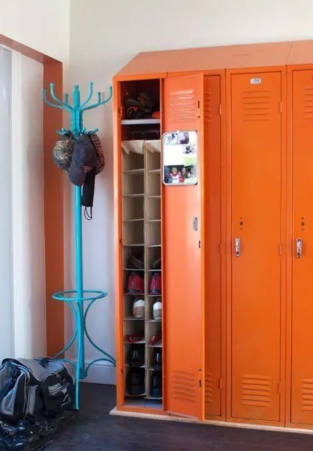 a mudroom with bold orange lockers and a blue rack is a cool and bright space, and these colors raise the spirits