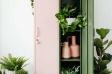 a pink and green locker as a plant stand and a storage unit, with lots of greenery inside, on top and around it
