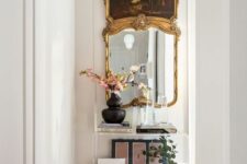 a refined mirror in a gilded frame is a chic and lovely idea for an entryway and it will add an elegant and exquisite touch to the space
