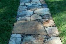 a rough stone garden path with little pebbles in between is a stylish and very simple idea