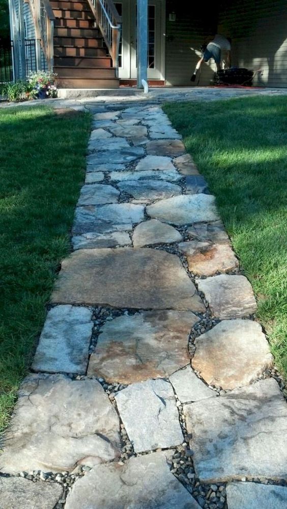 a rough stone garden path with little pebbles in between is a stylish and very simple idea