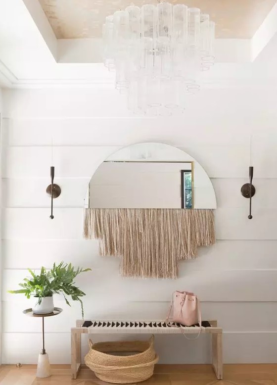 a semi circle mirror with long neutral fringe is a lovely solution for a mid-century modern or boho space