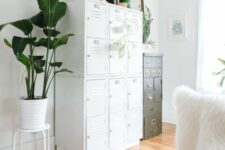 a stack of white lockers and a vintage file cabinet look very nice and cohesive together providing you with a lot of storage space
