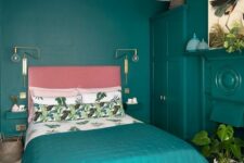 a super bold modern bedroom done in turquoise to emerald, with a pink bed and turquoise bedding and potted plants