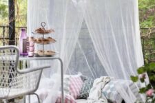 a terrace with a pillow space with rugs and a mosquito net over – invite your kids to spend time there without any bugs