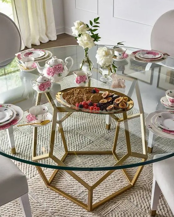an elegant modern dining table with a gold geometric base and a round tabletop that makes the base part of decor