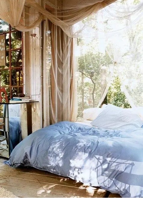 a cozy outdoor bedroom with a mosquito net