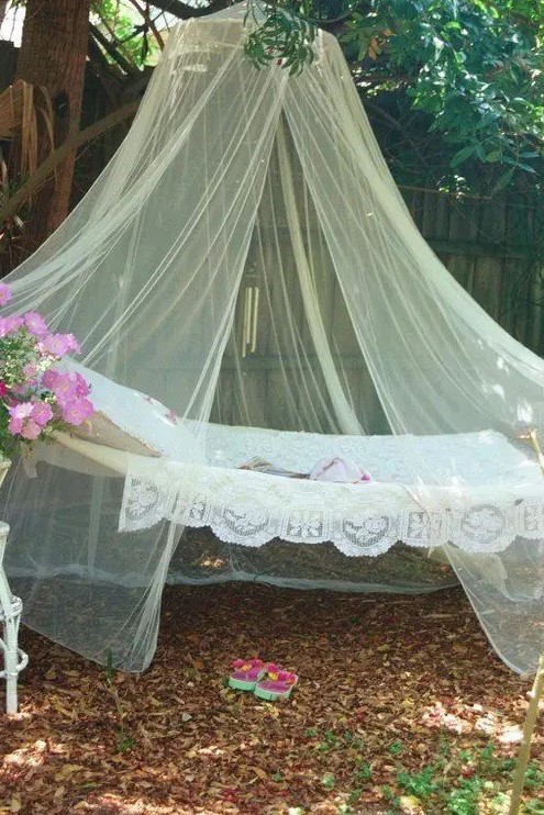an outdoor hammock covered with a large mosquito net to nap and avoid the bugs during sleeping