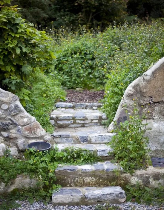 stone steps with pebble pathways and greenery growing here and there make the space look cooler