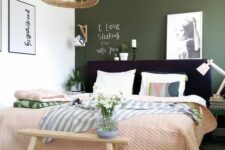 02 a bright bedroom with an olive green accent wall, a black upholstered bed with bright bedding, a bench and some lamps