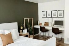 09 a lovely and functional bedroom with an olive green accent wall, a white bed with bedding, built-in desk, black chairs and a gallery wall
