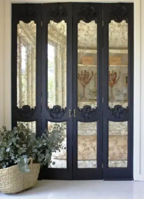 refined black frame mirror doors with exquisite detailing is a chic idea for a Pax wardrobe