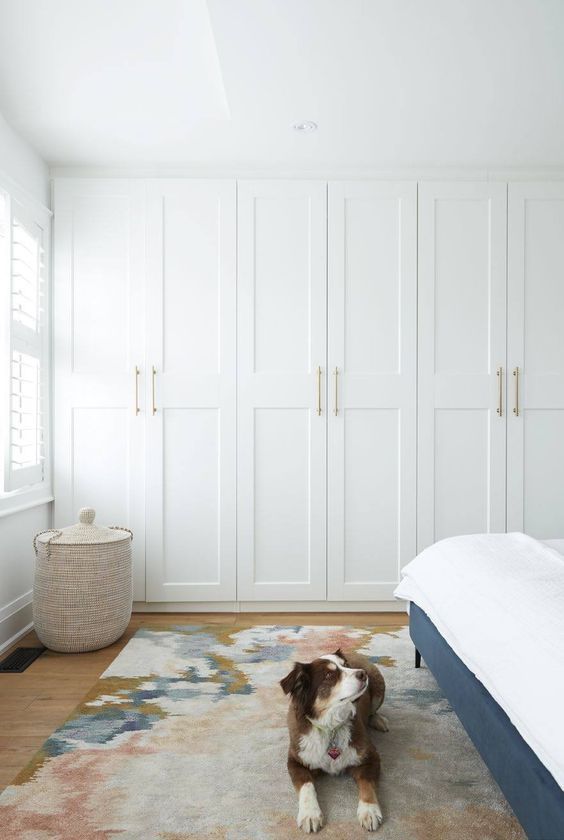 a lovely neutral bedroom with built in ikea pax wardrobes