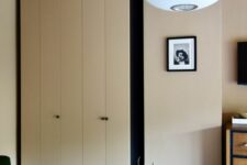 20 a neutral bedroom featuring a two-tone IKEA Pax wardrobe with black knobs that makes a statement in the space