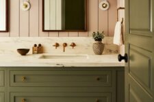 40 a chic bathroom with pink shiplap walls, an olive green vanity and a matching door, sconces and baskets
