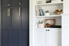 42 navy paneled front doors plus brass handles give a Pax item a chic look and amke it perfect for a modern farmhouse space