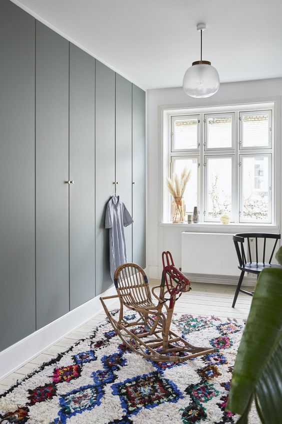 sleek built-in grey IKEA Pax wardrobes with gold knobs are an elegant and chic idea for a Scandinavian or modern space