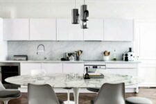 a Scandinavian kitchen in white, with an eating zone with an oval table and grey Tulip chairs