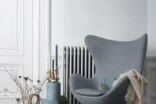 a cool Scandinavian space with a grey Egg chair, some vintage decor, boxes and candleholders is a very lovely nook